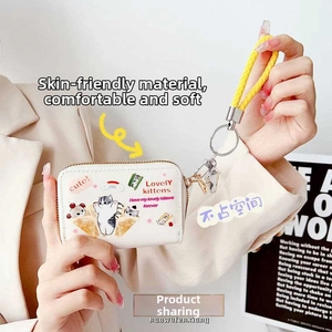 Close-up of cute white cat printed wallet with zipper closure and yellow wristlet strap