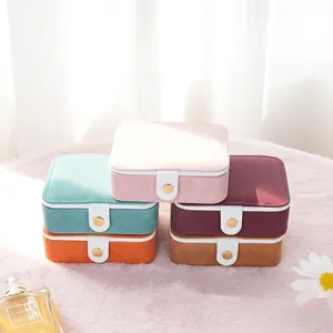 Mini velvet jewelry boxes with metal snaps in multiple colors for portable storage