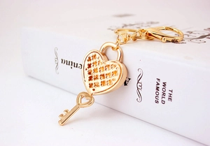 Macro shot of gold heart-shaped padlock with star cutout and matching key on book