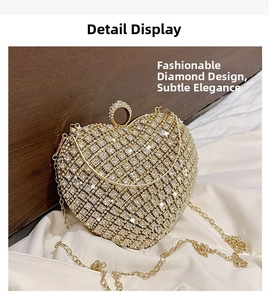 Macro view of gold heart clutch bag featuring sparkling rhinestones and crystal ring clasp
