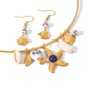 Golden starfish and shell necklace set with blue beads and pearls on white background