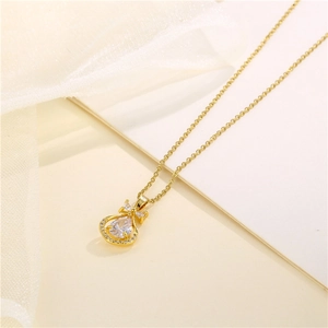 Gold stainless steel bow necklace featuring a teardrop zircon pendant on a thin chain