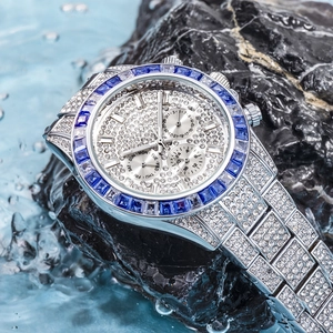Silver luxury chronograph watch with blue gems and diamonds splashing in water
