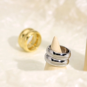 Macro detail of high-polished gold and silver double-layered minimalist steel rings