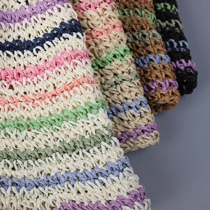 Close-up of handmade crochet straw hat featuring colorful stripes and fine woven textures