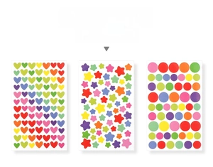 Close-up of colorful heart, star, and circle stickers for DIY scrapbooking decoration