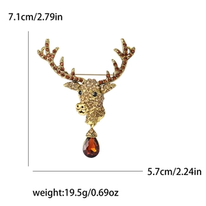 Vintage reindeer brooch with brown rhinestones and amber crystal drop on white background