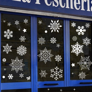 Adesivi per vetrine natalizie con fiocchi di neve bianchi e stelle per negozi e porte