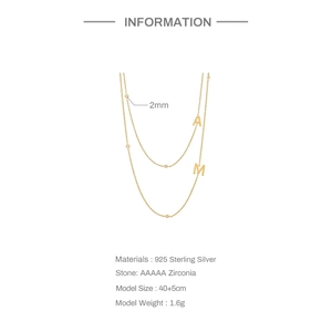 Detail of 925 sterling silver layered necklace with A and M pendants and zircon stones