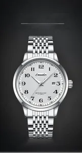 Detailed view of white textured watch dial with date window and silver steel strap