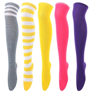 Close-up of over-the-knee socks in colorful stripes and solid knits on leg forms