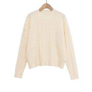 Classic cream cable-knit sweater with a round neck and relaxed drop shoulder design