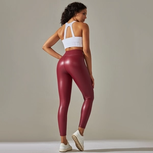 Rear view of high-waisted dark red faux leather leggings with shiny metallic finish