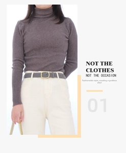 Close-up of grey suede leather belt with gold oval metal buckle on a white background