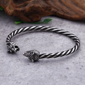 Macro shot of Viking wolf head torque bangle with detailed twisted rope pattern engraving