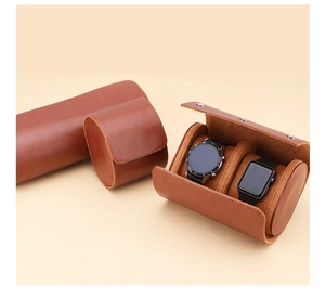Detail of brown leather watch rolls with soft suede lining and metal button snaps