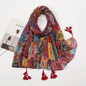 Red bohemian cotton linen feel scarf with ethnic prints and decorative tassels on white