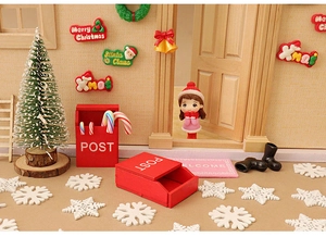 Miniature dollhouse scene with red post boxes, Christmas tree and Santa Claus figurines