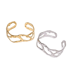Irregular hollow open cuff bracelet in 18k gold and silver titanium steel lava texture