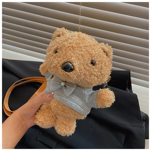 Close-up of brown teddy bear plush crossbody bag with gray hoodie and pearl detail