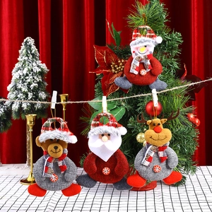 Close-up of four plush Christmas ornaments including Santa, bear, reindeer, and snowman