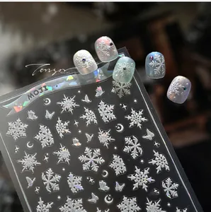 Close-up of 5D embossed snowflake nail art stickers with aurora laser effect and gems