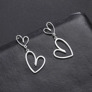 Silver stainless steel long earrings featuring hollow heart-shaped dangle charms