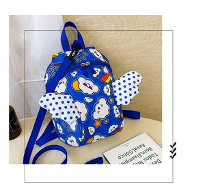 Detail of blue toddler backpack featuring white clouds, rainbows and 3D wings with dots