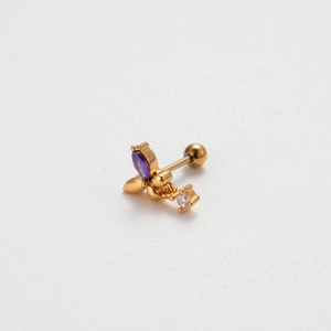 Macro shot of gold stainless steel cartilage stud with marquise purple stone and white zircon