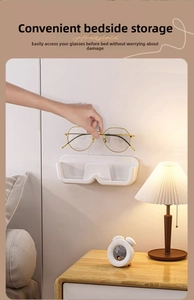 Close-up of wall-mounted glasses holder on bedside with warm cozy lighting scene