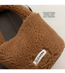 Macro texture of caramel faux shearling fabric with a stitched CLEAR❤K woven label