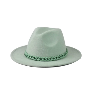 Detail of mint green fedora hat featuring a matching thick chain accent in retro style
