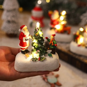 Detailed close-up of a resin glowing Christmas ornament with LED warm light and snow base