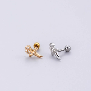 Detail of gold and silver dagger stud earrings with sparkling cubic zirconia inlay