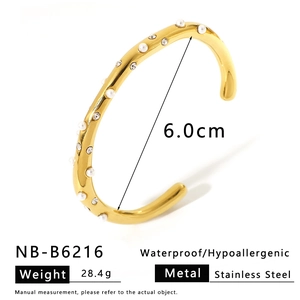 Macro detail of 18K gold plated stainless steel bracelet with pearls and crystals