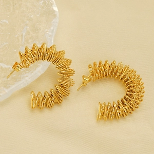Golden C-shaped wire wrapped stud earrings with glossy metallic coil finish