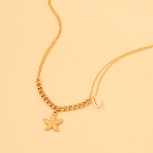Detailed macro view of gold-plated starfish and natural shell charms on a double chain necklace