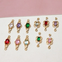 Macro view of gold-plated filigree charms with multi-colored cubic zirconia for DIY jewelry