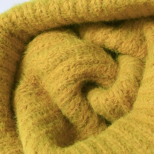 Chunky cable knit slouchy beanie in warm yellow fluffy yarn for winter warmth