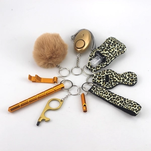 Detailed set of leopard print and gold self-defense keychain with alarm and accessories