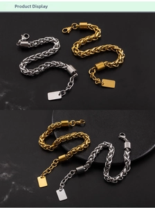 Detail of gold and silver thick wheat link bracelets with a rectangle tag and lobster clasp