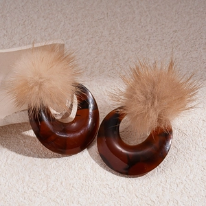 Vintage tortoiseshell resin hoop earrings with beige pom poms and silver needles