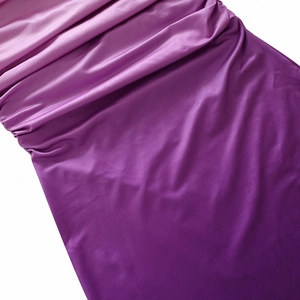 Detail shot of purple satin fabric texture with elegant silky luster and drapery effects
