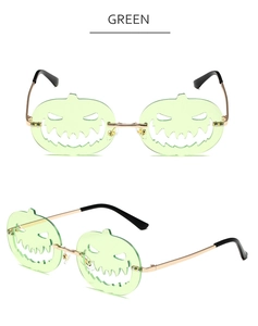 Close-up of green pumpkin-shaped lenses with hollow metal frame for Halloween