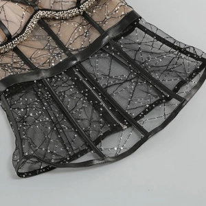 Detail of sequin embroidery and metal back zipper on black mesh bodycon dress