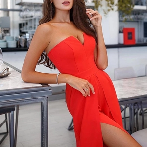 Close-up of red slim-fit jumpsuit featuring a high slit and stylish strapless V-neckline