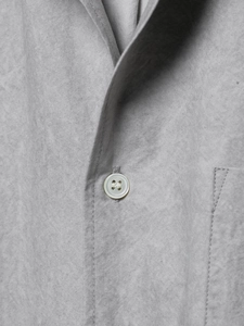 Macro detail of high-quality grey fabric texture and premium white button closure