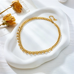 Minimalist gold titanium steel curb chain necklace with bead charms on white tray