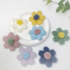 Flat lay of colorful felt flower accessories for garments and DIY decorations