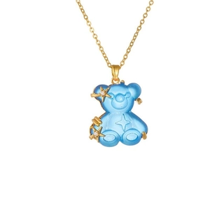 Detail of a blue resin bear pendant with gold star accents on a delicate chain necklace